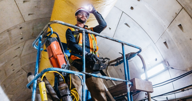 Worker operating machinery in tunnel