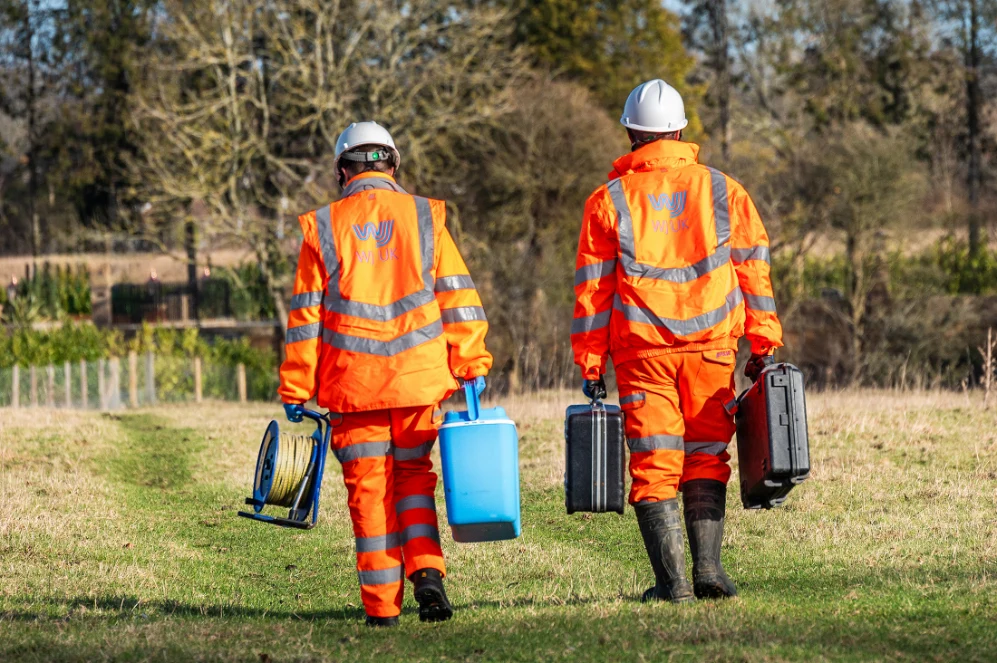 Two workers in orange safety gear | surface water monitoring