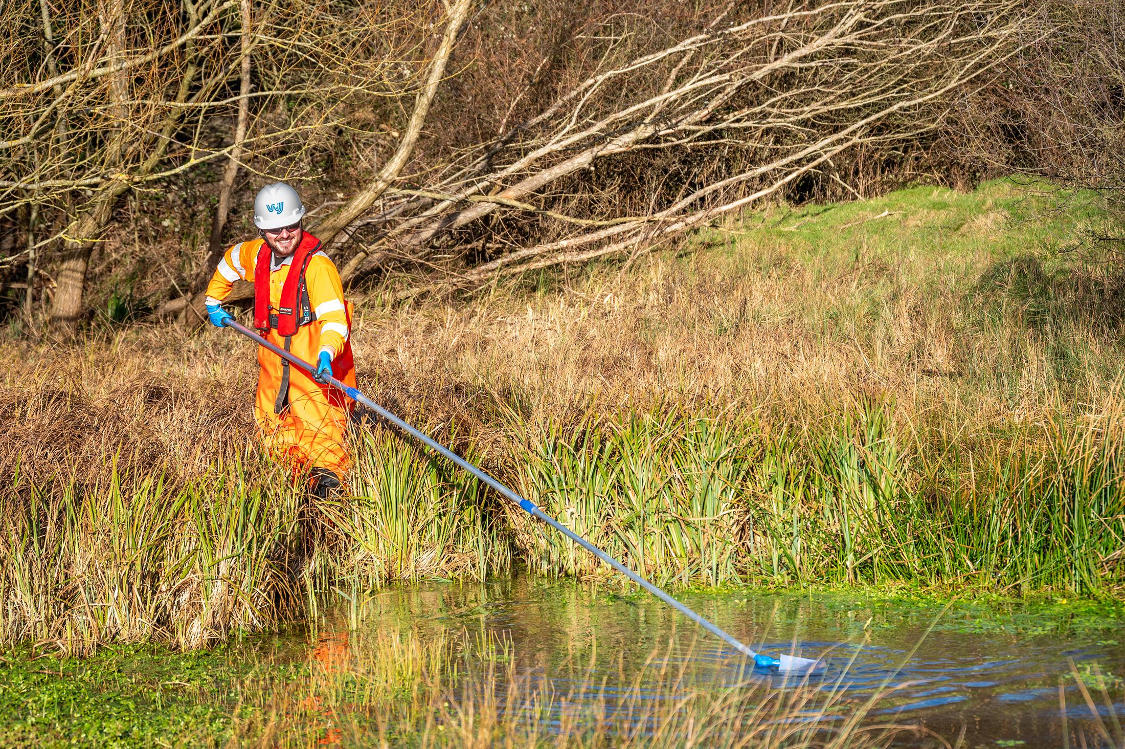 Person testing water with equipment.