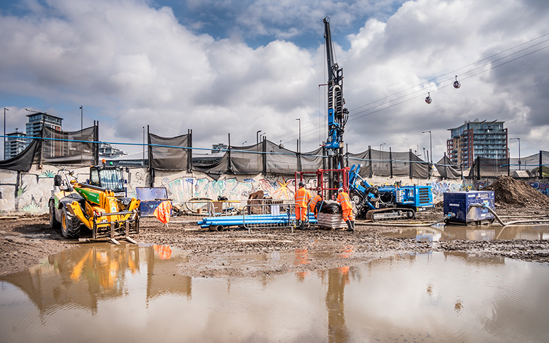 WJ UK Services: drilling rig and crew installing a deep well on a major infrastructure construction site, supporting dewatering operations in an urban setting.