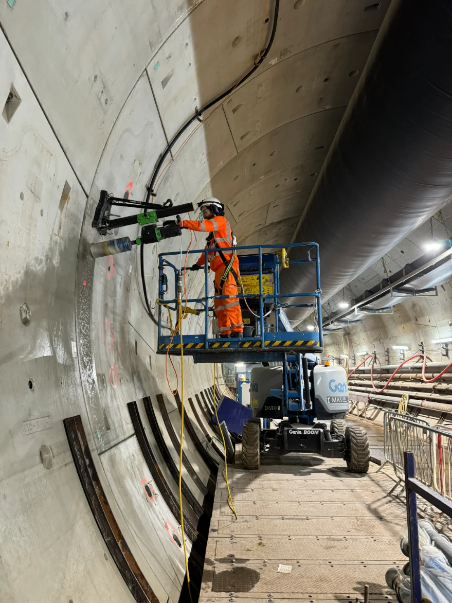 Worker operating machinery in tunnel. Northolt Tunnel West - dewatering