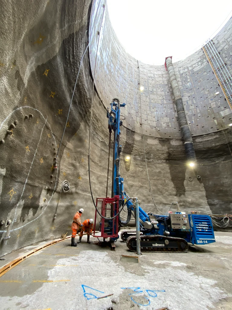 Construction workers inside deep cylindrical shaft. Northolt Tunnel Shafts - dewatering