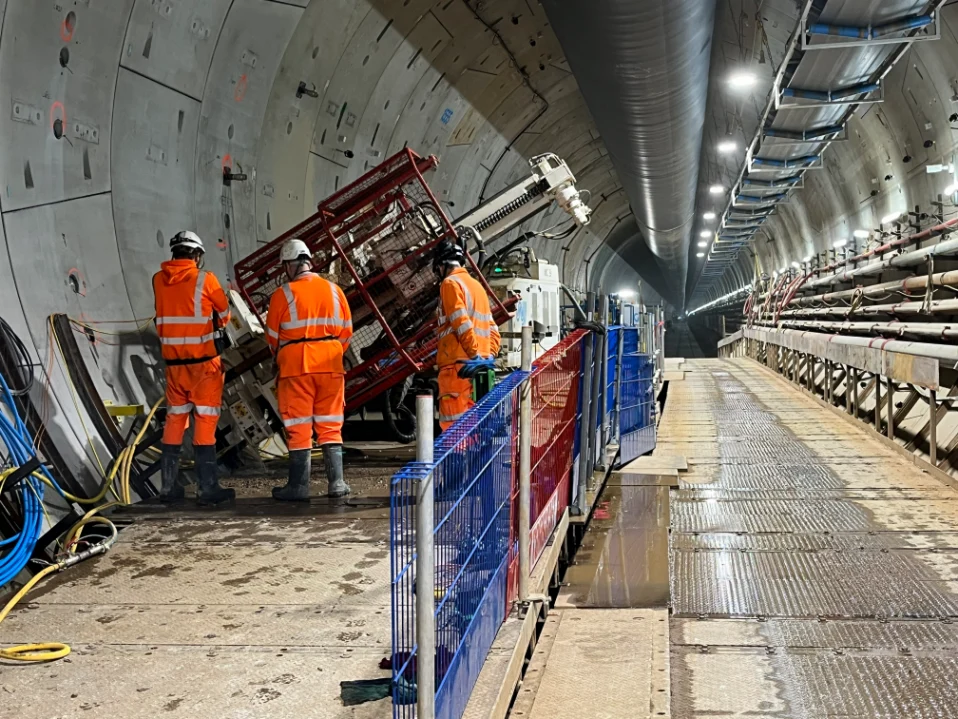Workers in tunnel with equipment