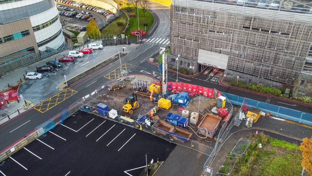 Construction site with drilling equipment visible. For ground source heating.